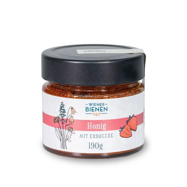 190g-Glas Wiener Bienen Cremehonig mit Erdbeeren, hellrote Farbe und weißes Etikett mit Erdbeer-Illustration.